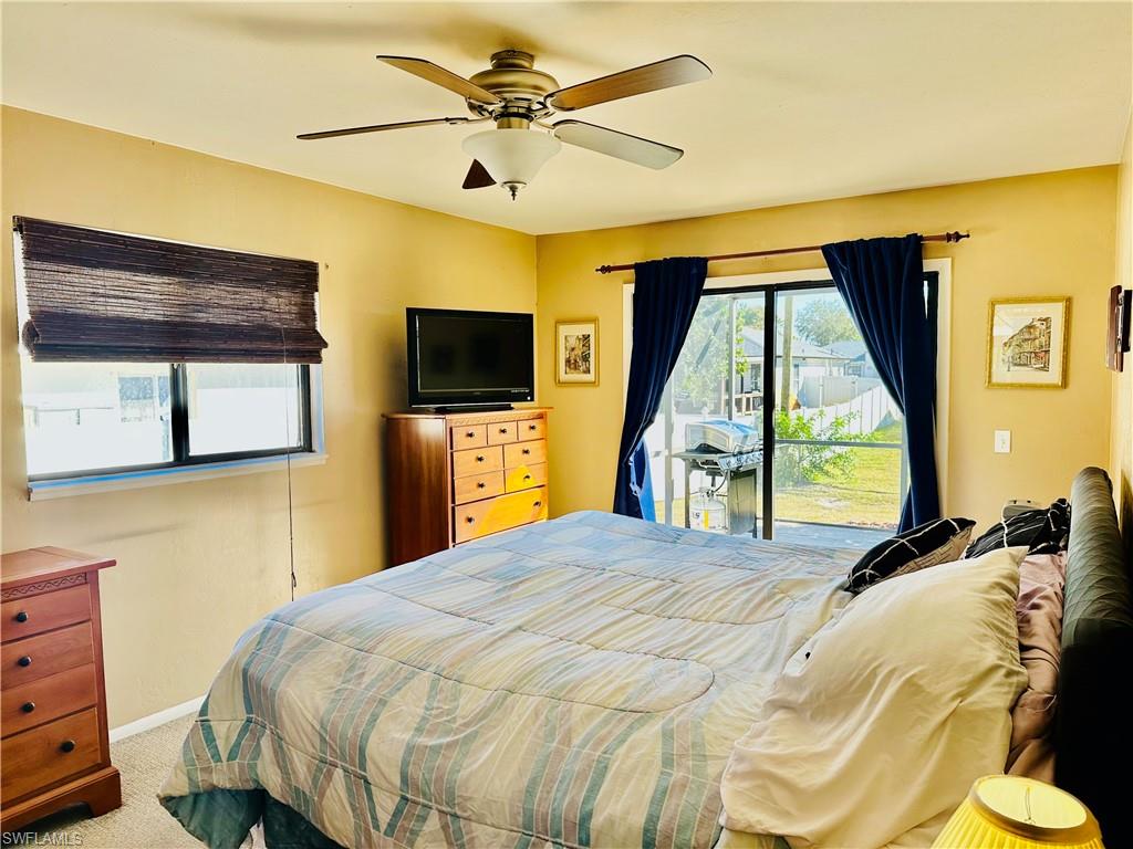 9108 Caloosa Road Fort Myers, FL 33967 - Photo 11 of 19 a bedroom with a bed and a flat screen tv