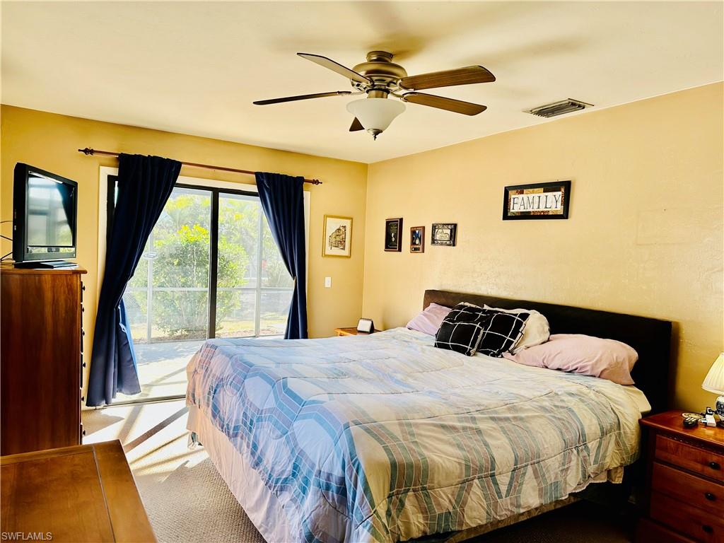 9108 Caloosa Road Fort Myers, FL 33967 - Photo 12 of 19 a bedroom with a bed and a large window with outer view