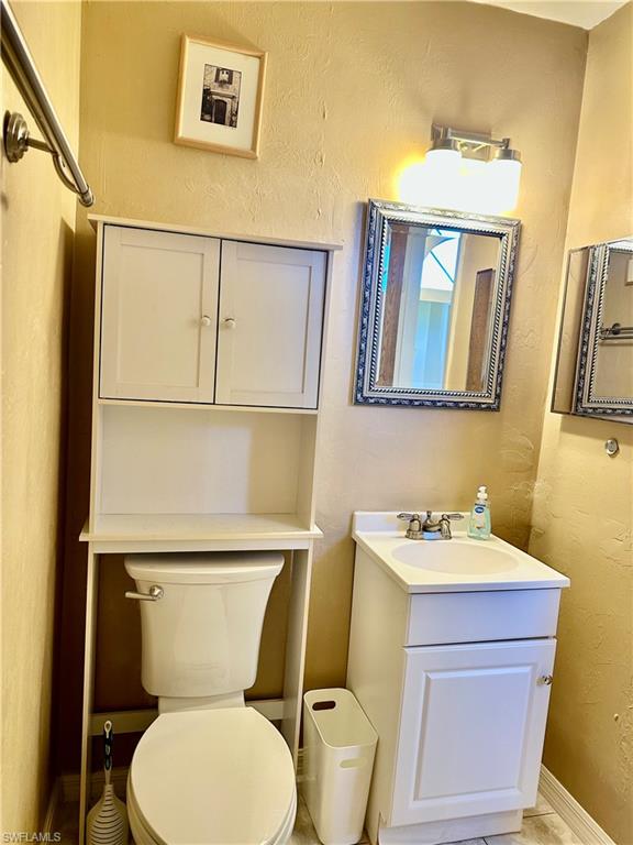 9108 Caloosa Road Fort Myers, FL 33967 - Photo 14 of 19 a white toilet sitting next to a bathroom sink