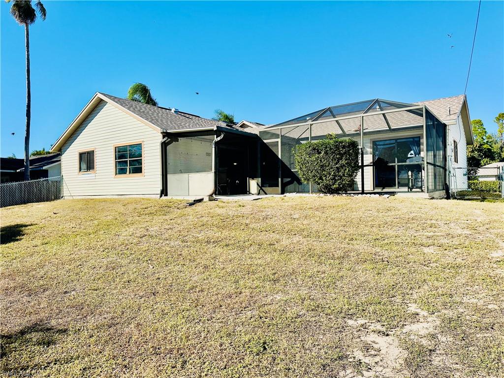 9108 Caloosa Road Fort Myers, FL 33967 - Photo 18 of 19 a view of house with yard and garage
