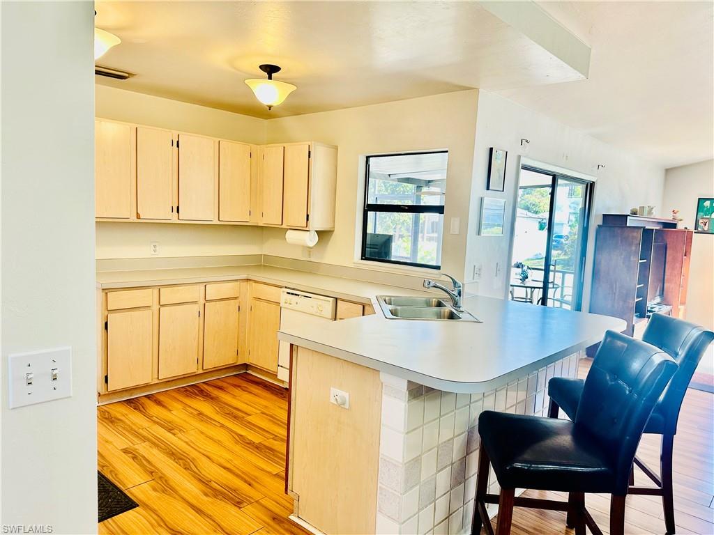 9108 Caloosa Road Fort Myers, FL 33967 - Photo 4 of 19 a kitchen with a table chairs sink and cabinets