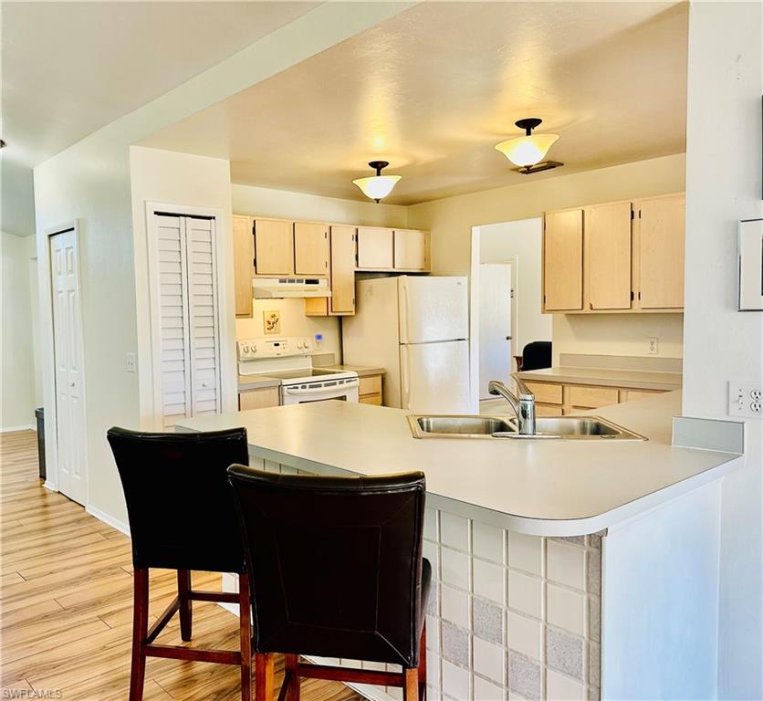 9108 Caloosa Road Fort Myers, FL 33967 - Photo 5 of 19 a kitchen with a table chairs sink and cabinets