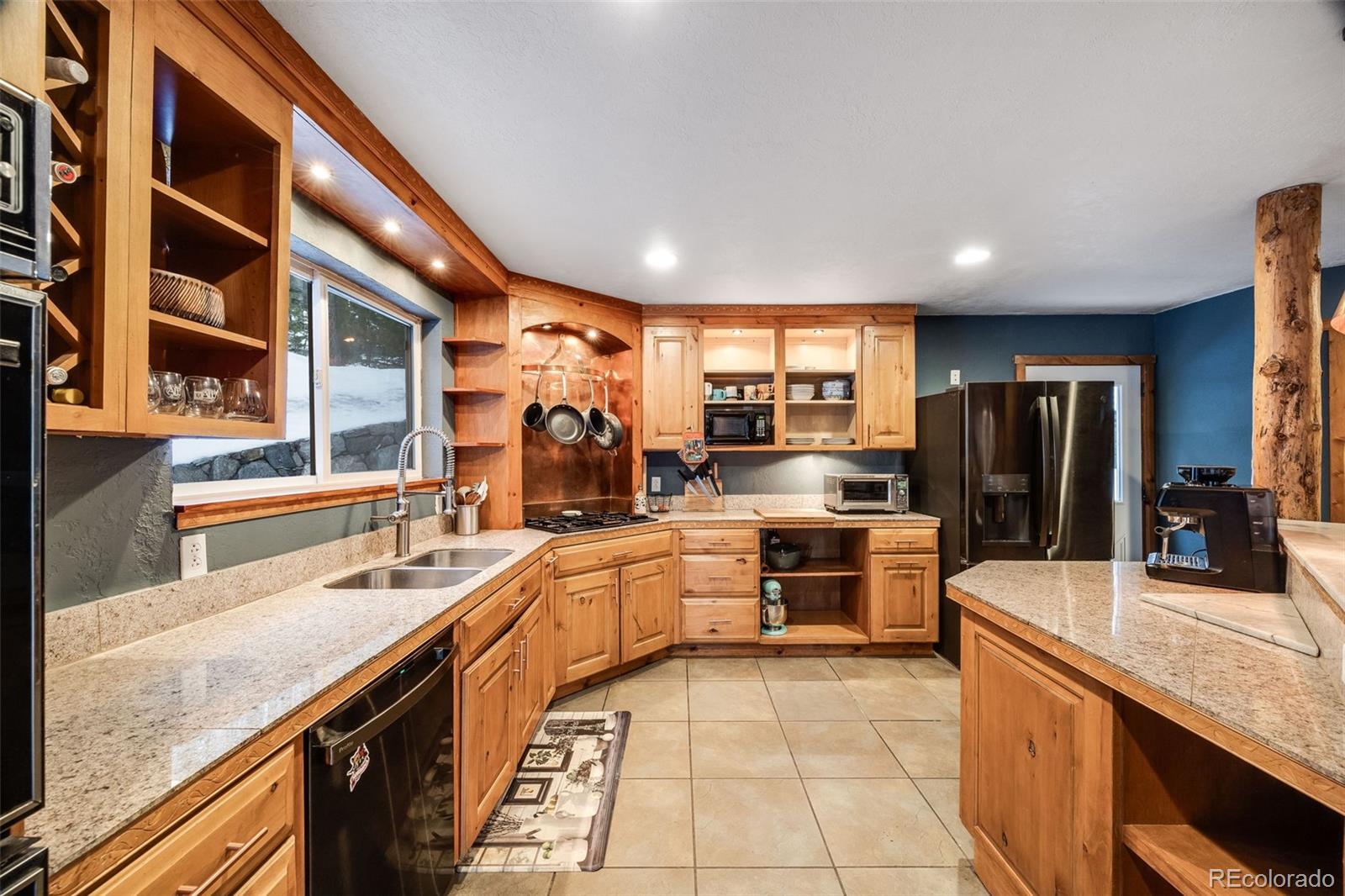 46 Apache Road Evergreen, CO 80439 - Photo 13 of 46 a room with stainless steel appliances granite countertop a sink and counter space