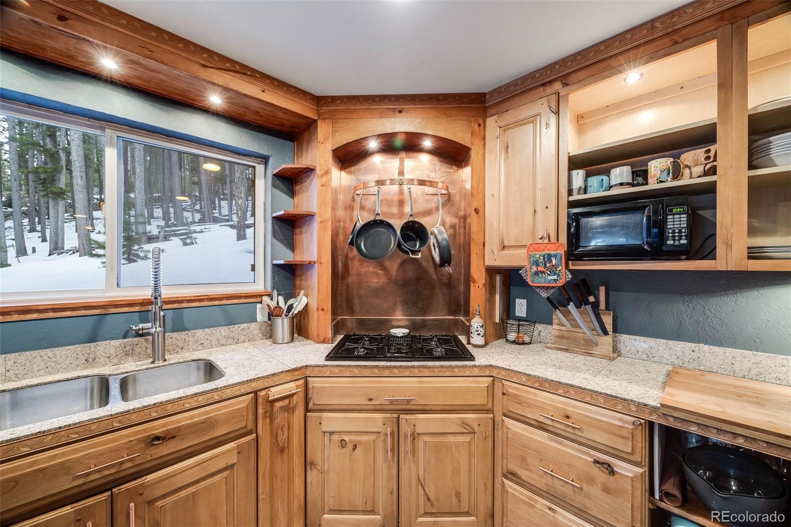 46 Apache Road Evergreen, CO 80439 - Photo 14 of 46 a kitchen with a sink and a stove next to a large window