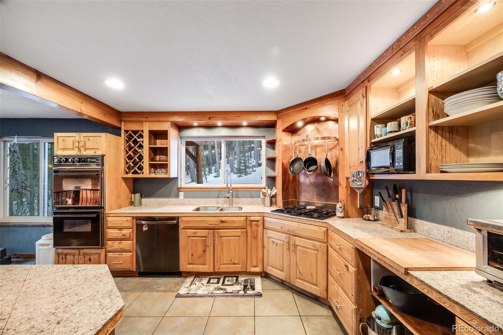 46 Apache Road Evergreen, CO 80439 - Photo 15 of 46 a kitchen with stainless steel appliances granite countertop a sink and cabinets