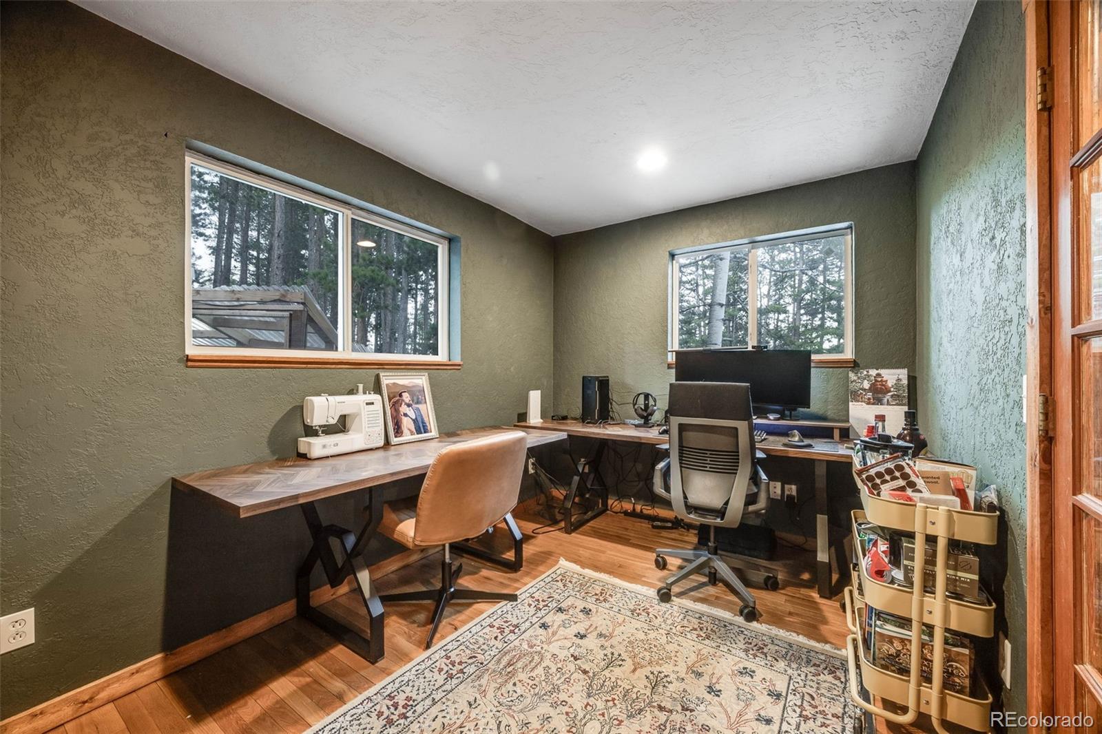 46 Apache Road Evergreen, CO 80439 - Photo 19 of 46 a view of a workspace with furniture and a window