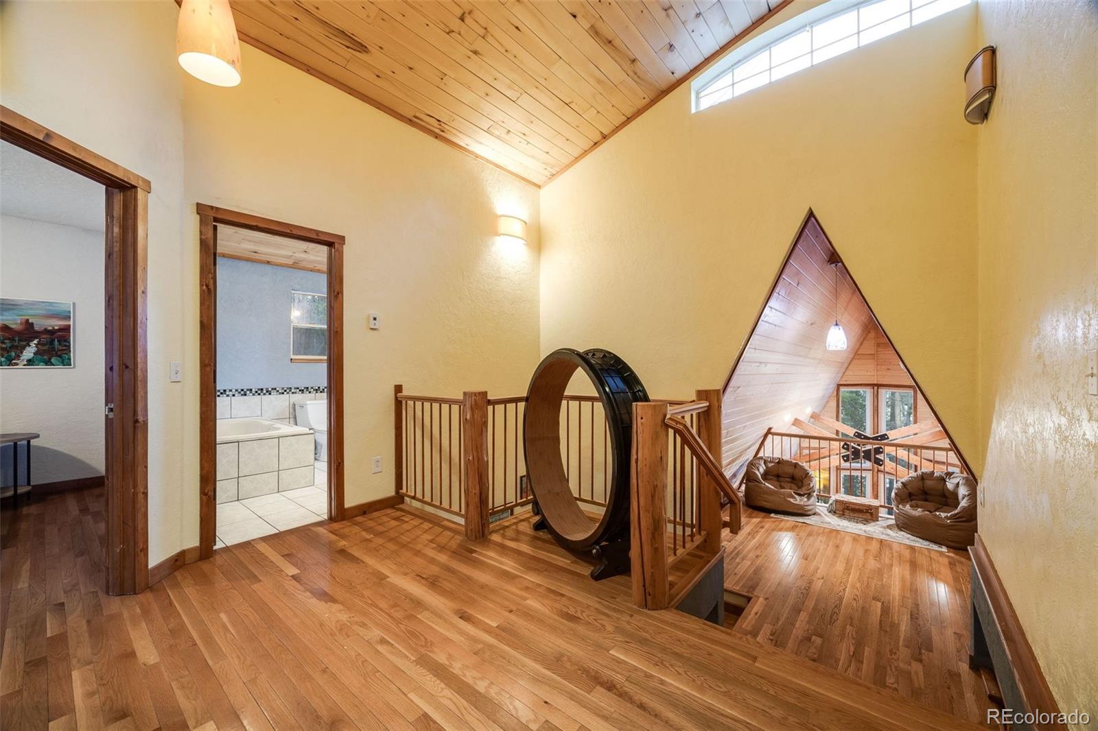 46 Apache Road Evergreen, CO 80439 - Photo 23 of 46 a view of a bedroom with wooden floor and white walls