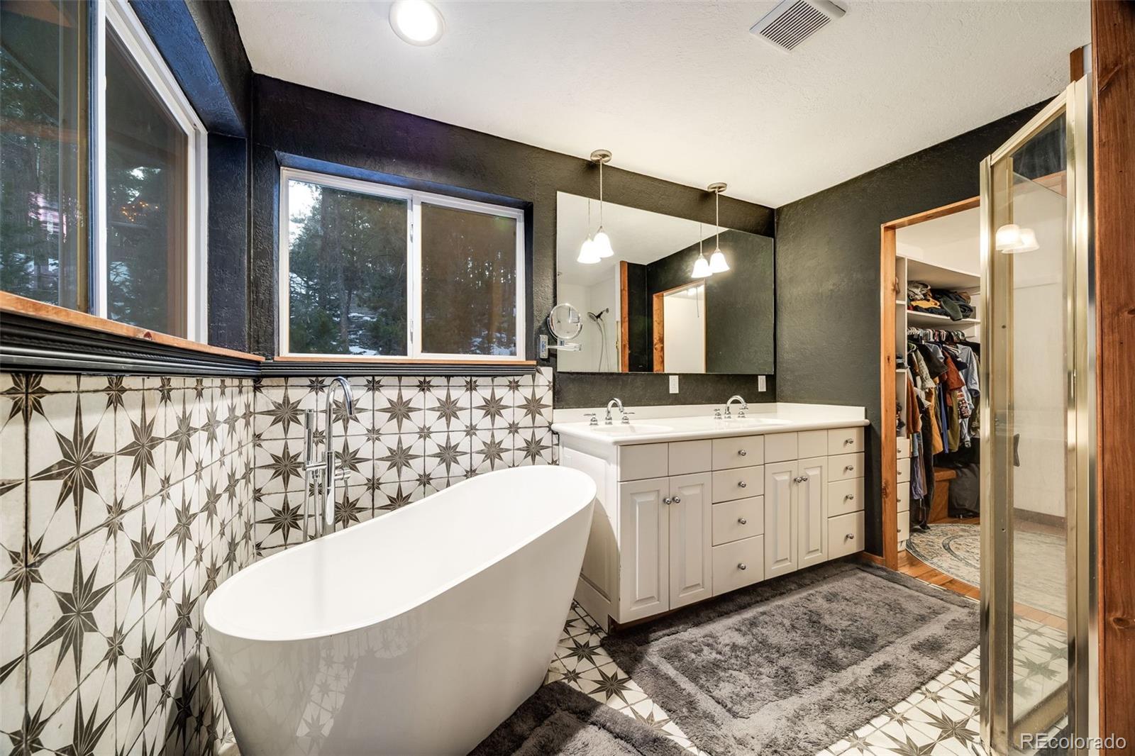 46 Apache Road Evergreen, CO 80439 - Photo 29 of 46 a spacious bathroom with a bathtub and a sink