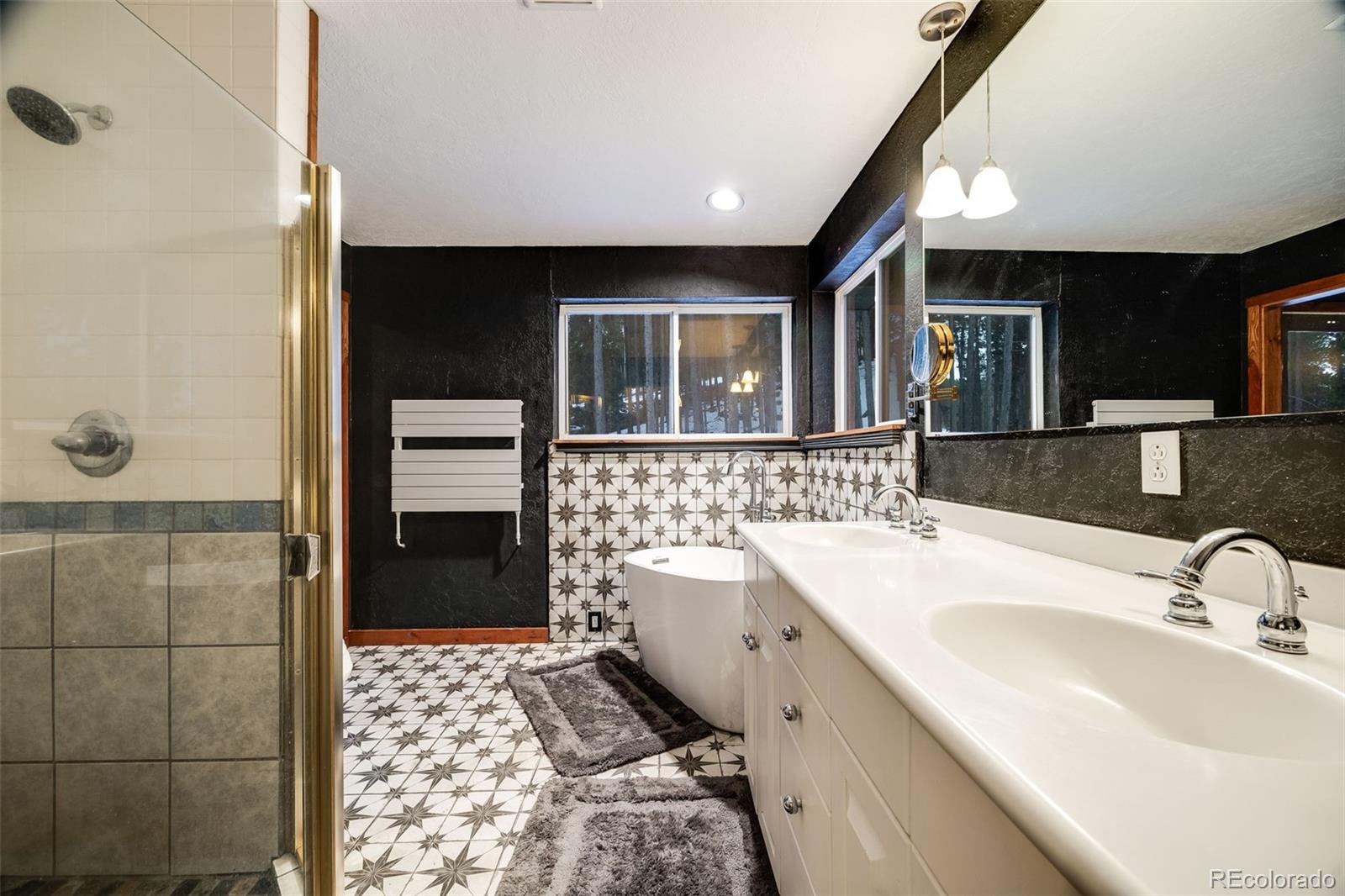 46 Apache Road Evergreen, CO 80439 - Photo 30 of 46 a bathroom with a sink and a bathtub