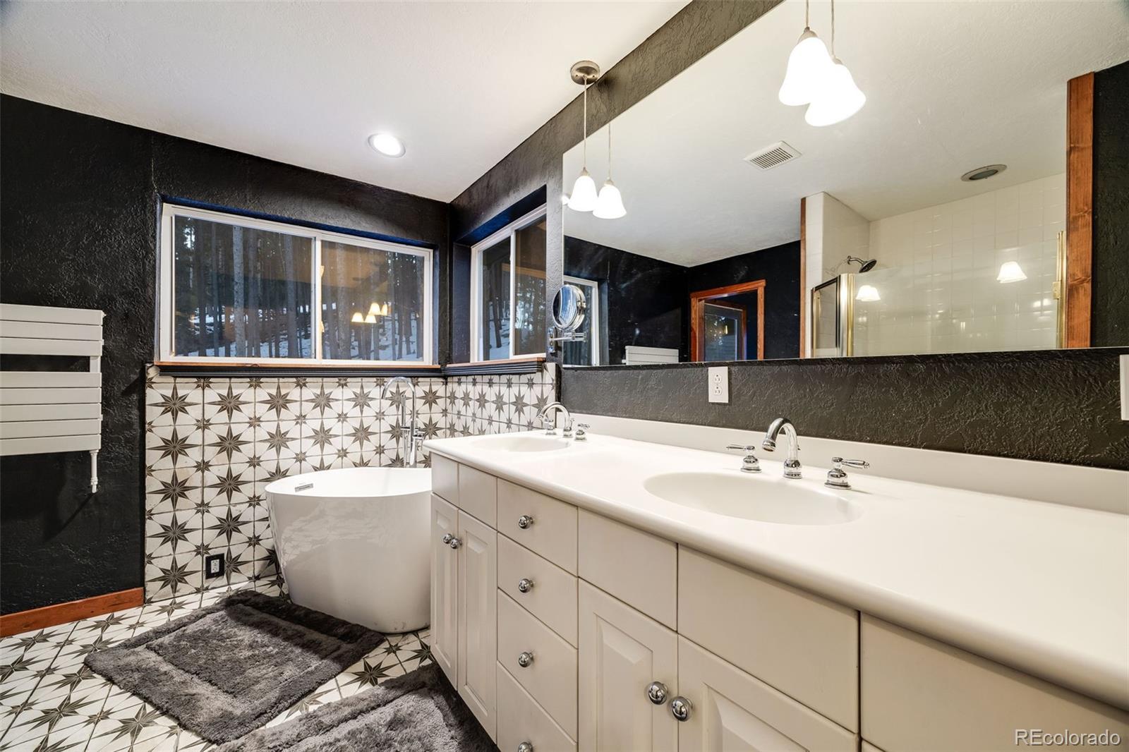 46 Apache Road Evergreen, CO 80439 - Photo 31 of 46 a bathroom with a sink and a mirror