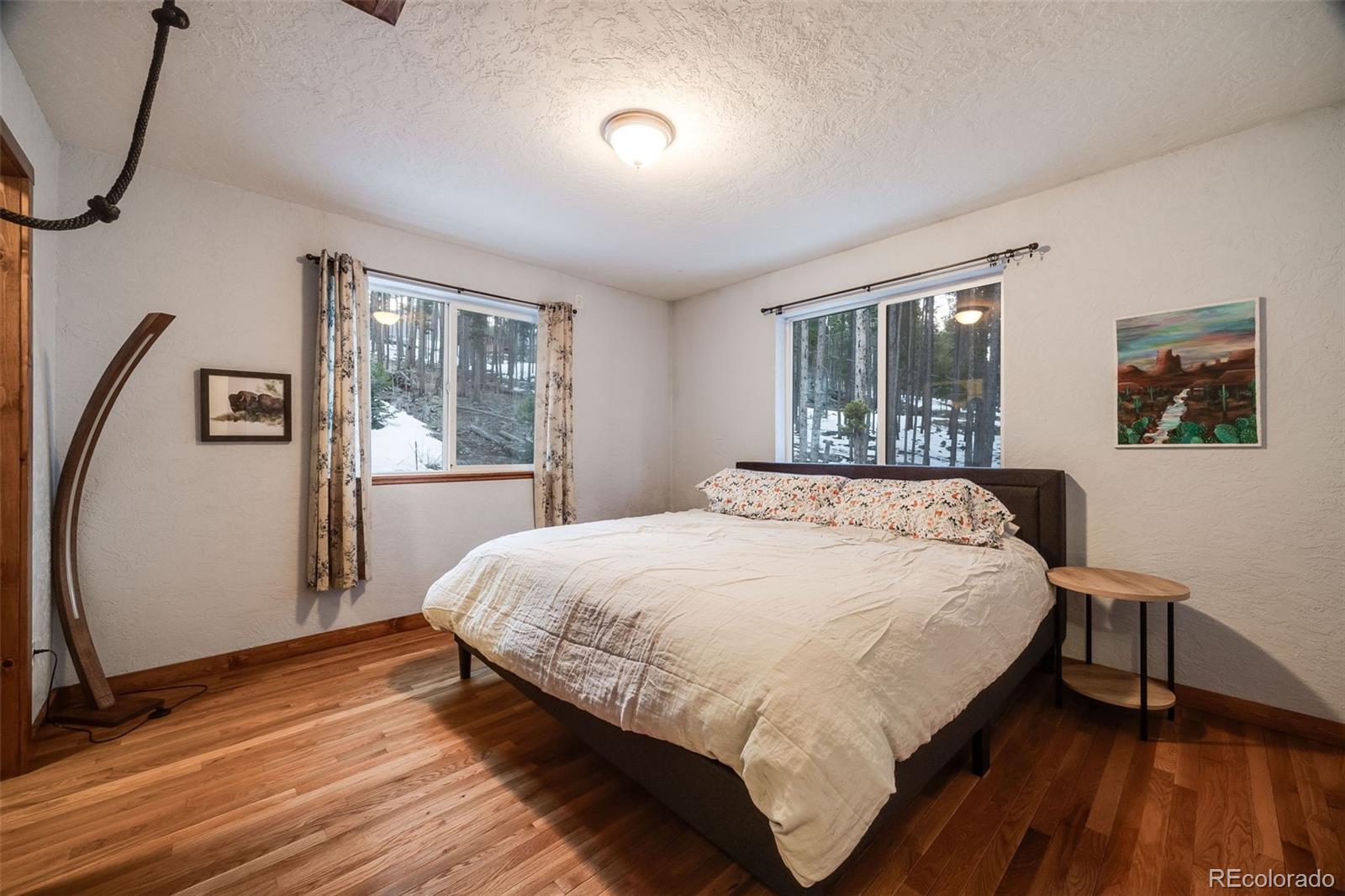 46 Apache Road Evergreen, CO 80439 - Photo 35 of 46 a bedroom with a bed and a large window