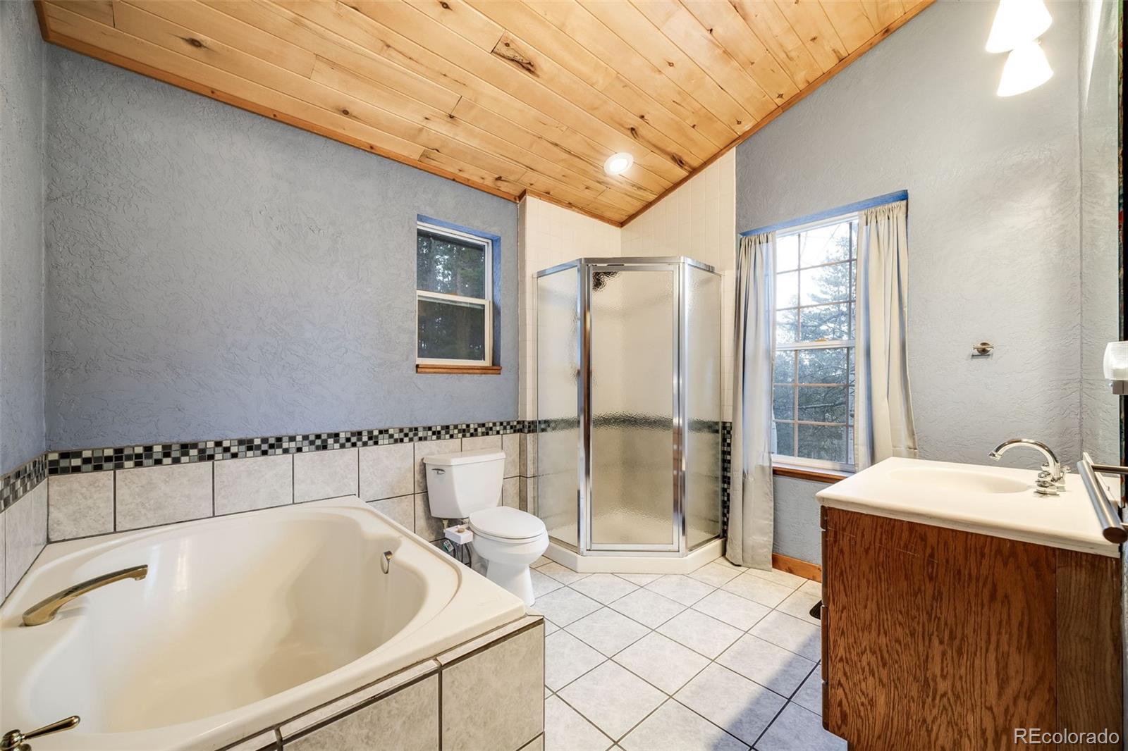 46 Apache Road Evergreen, CO 80439 - Photo 37 of 46 a bathroom with a tub sink and shower