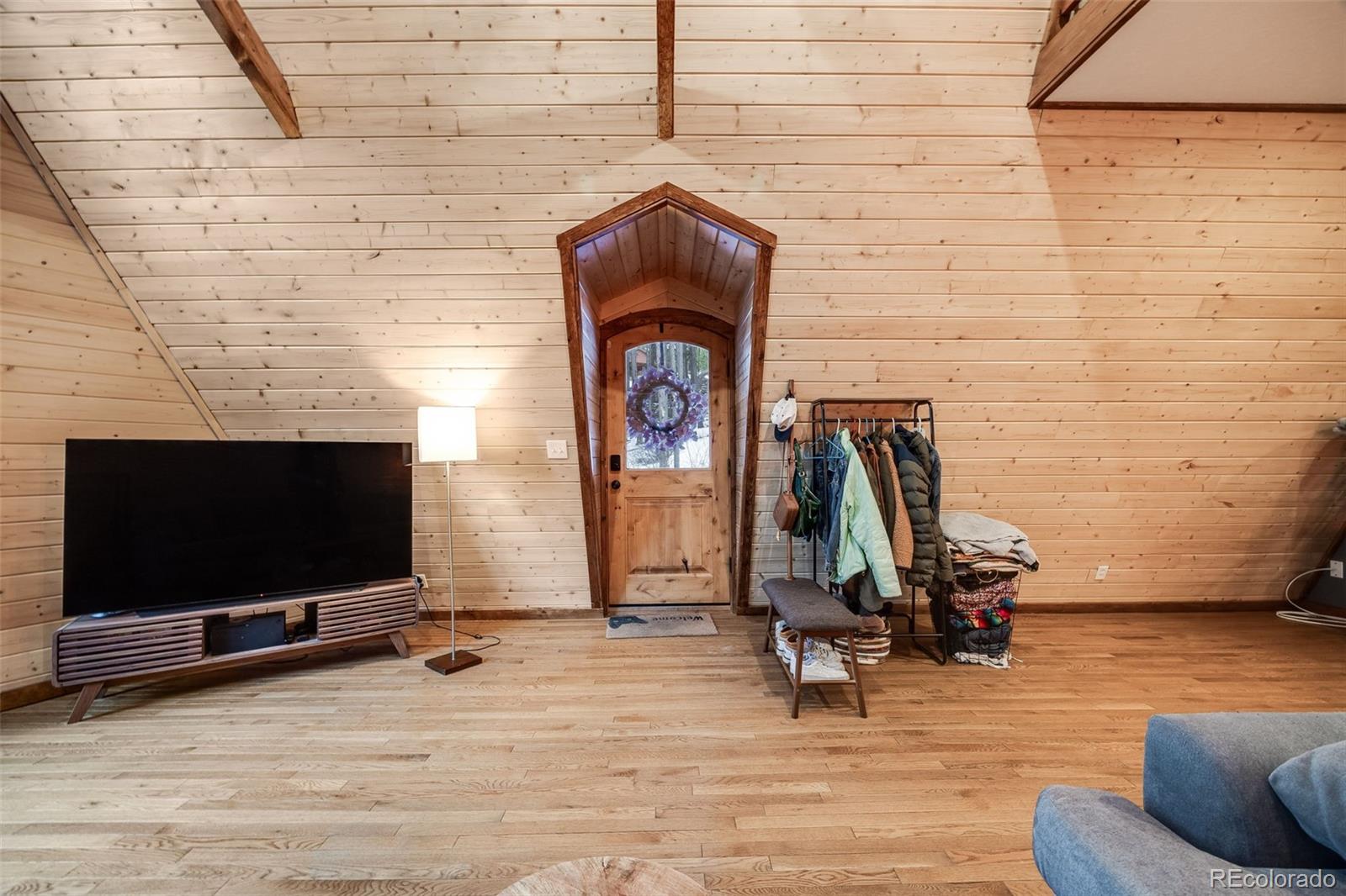 46 Apache Road Evergreen, CO 80439 - Photo 4 of 46 a living room with fireplace furniture and a flat screen tv