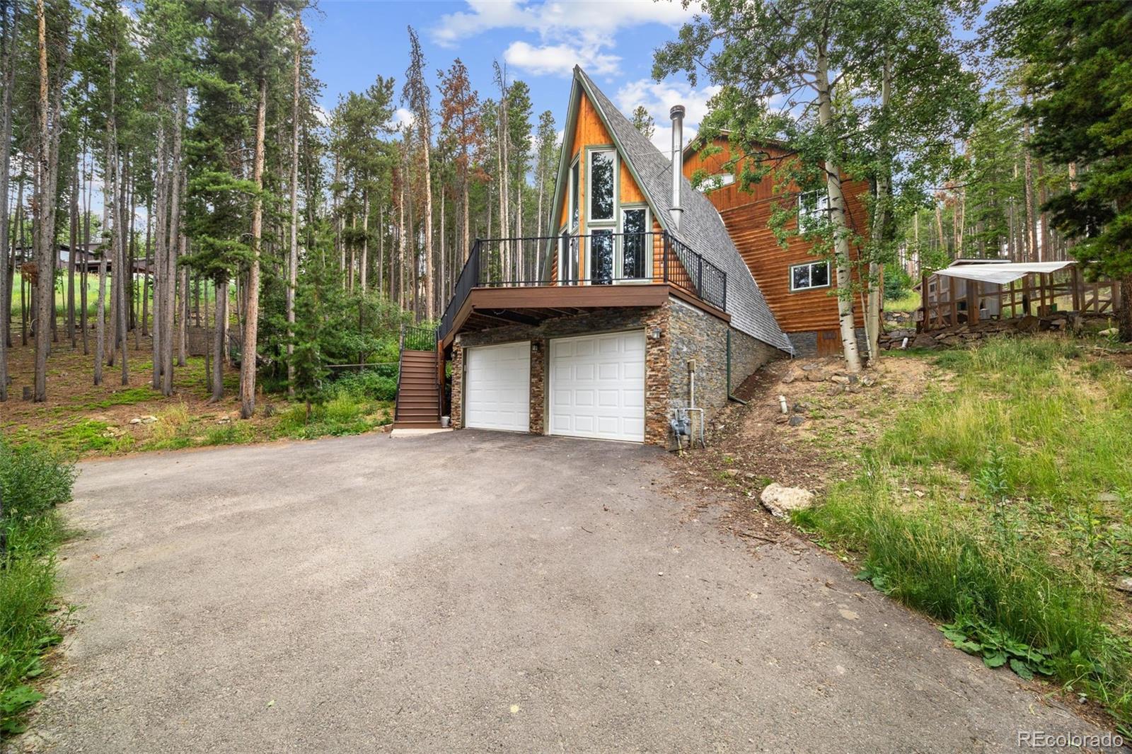 46 Apache Road Evergreen, CO 80439 - Photo 41 of 46 a view of a house with large windows and a small yard