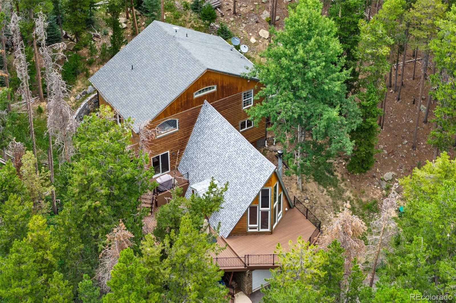 46 Apache Road Evergreen, CO 80439 - Photo 44 of 46 an aerial view of a house with yard and trees all around