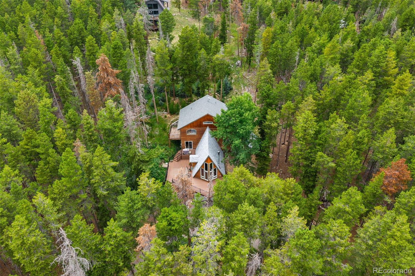 46 Apache Road Evergreen, CO 80439 - Photo 45 of 46 a sign that is sitting in front of a tree