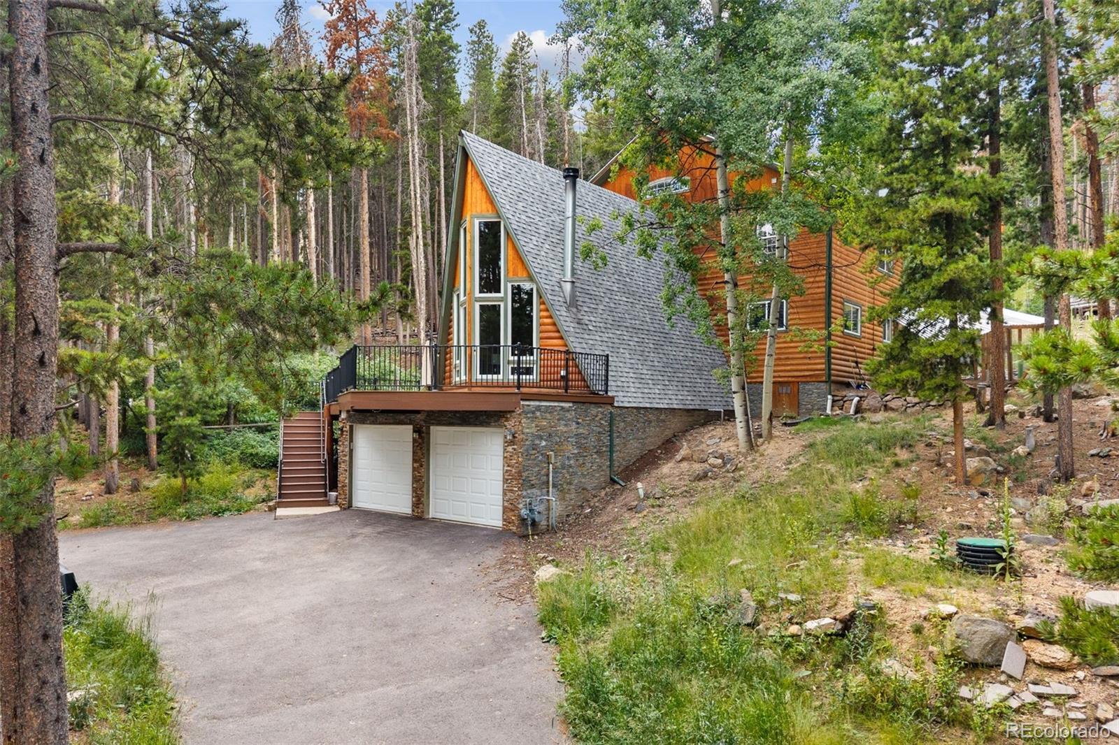 46 Apache Road Evergreen, CO 80439 - Photo 46 of 46 a view of a house with a yard and potted plants