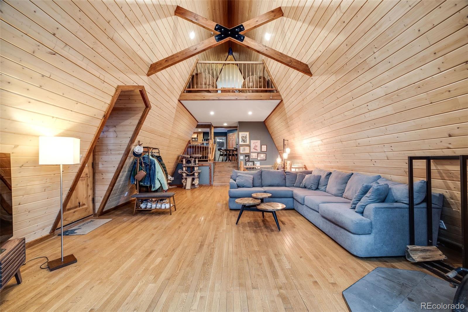46 Apache Road Evergreen, CO 80439 - Photo 7 of 46 a living room with furniture and a wooden floor
