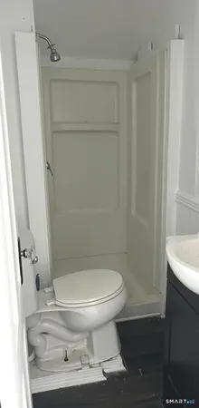 a bathroom with a toilet and a shower