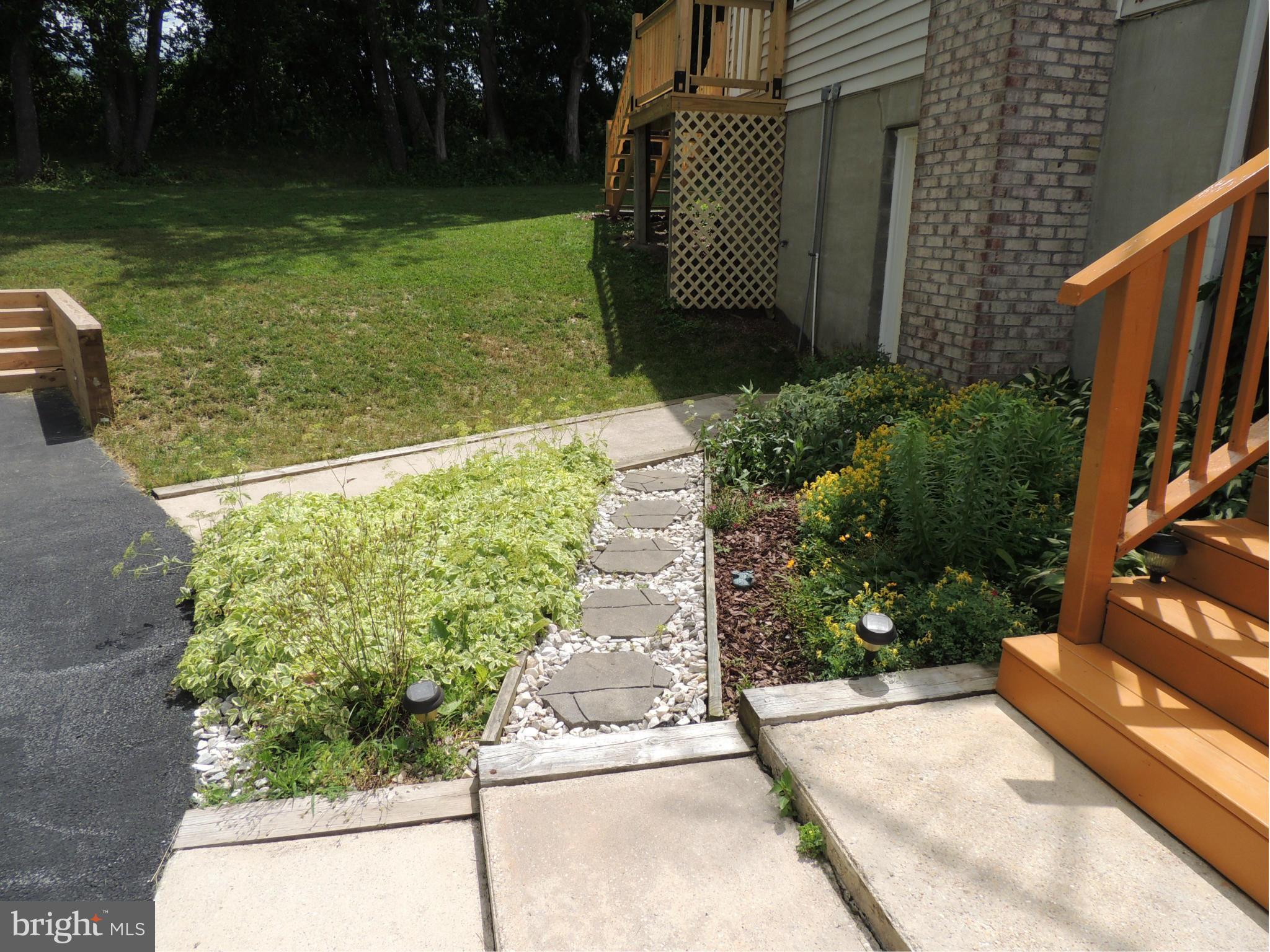 6044 Old Bohn Road Mount Airy, MD 21771 - Photo 22 of 30 a view of a garden with a chair