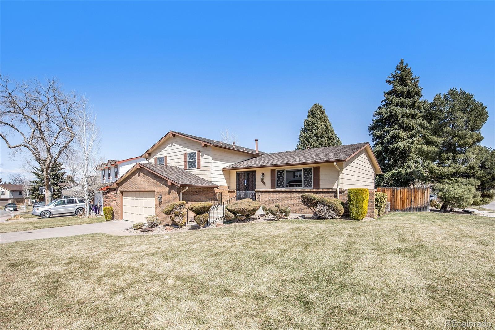 3792 South Fenton Way Denver, CO 80235 - Photo 1 of 19 a front view of a house with a yard
