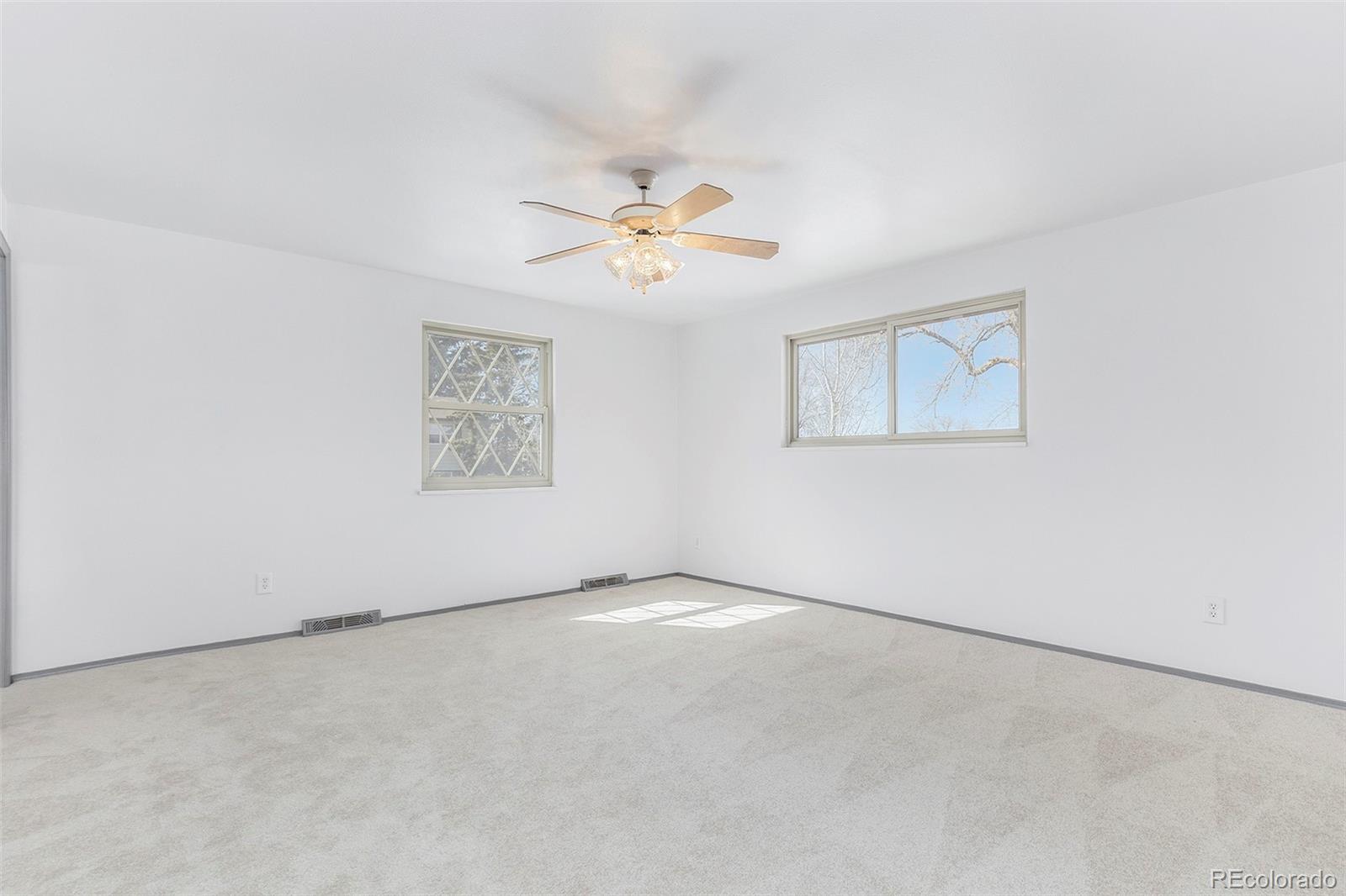 3792 South Fenton Way Denver, CO 80235 - Photo 11 of 19 an empty room with a window and a ceiling fan