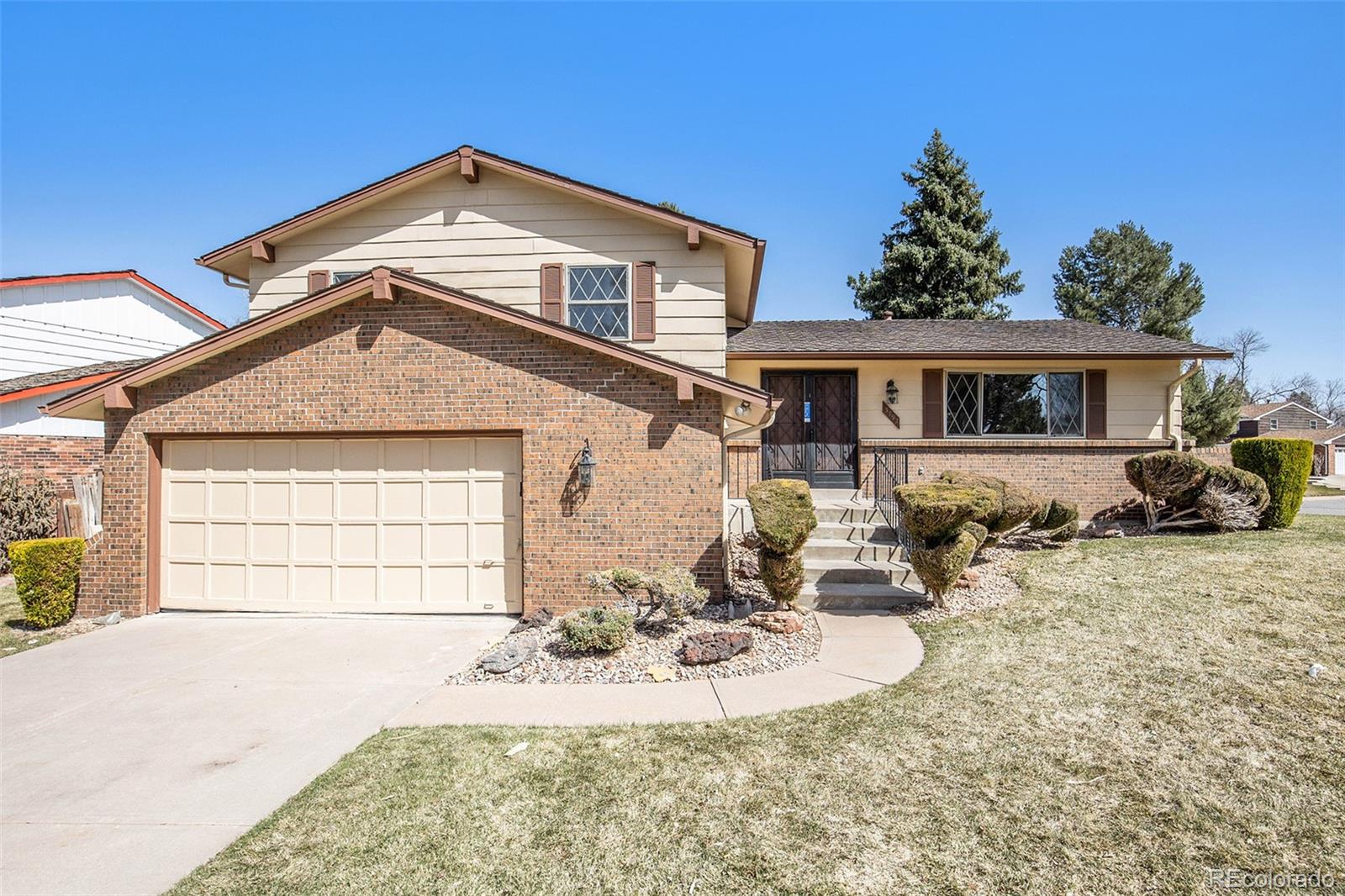 3792 South Fenton Way Denver, CO 80235 - Photo 13 of 19 a front view of a house with a yard
