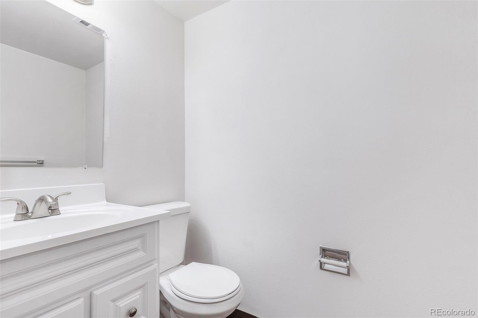 3792 South Fenton Way Denver, CO 80235 - Photo 14 of 19 a bathroom with a sink a toilet and mirror