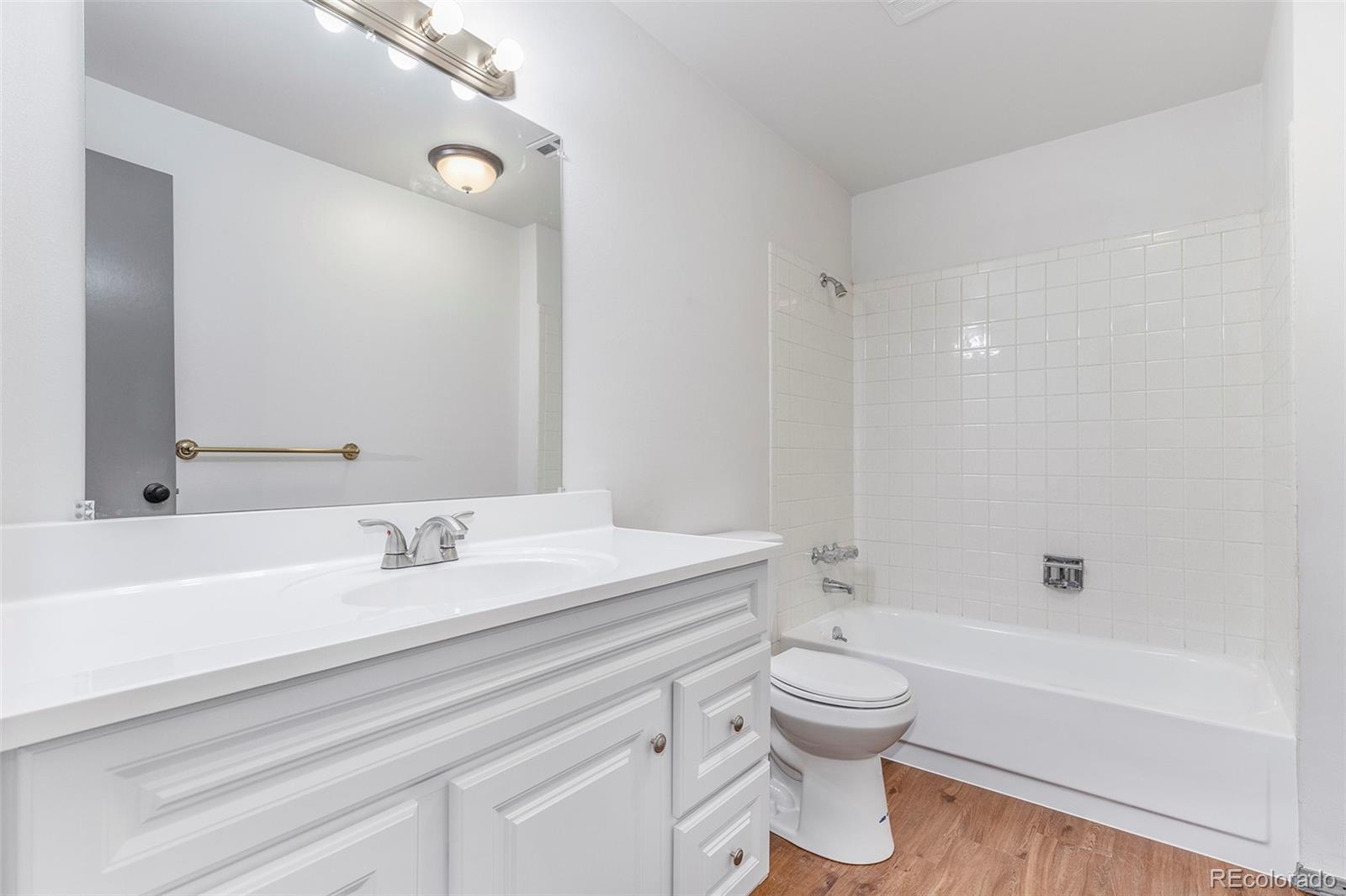 3792 South Fenton Way Denver, CO 80235 - Photo 17 of 19 a bathroom with a sink a toilet and a bathtub