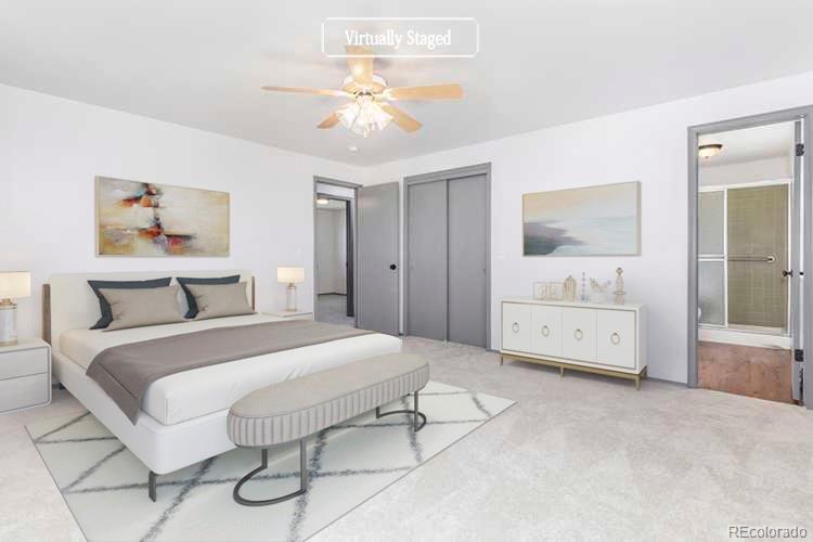 3792 South Fenton Way Denver, CO 80235 - Photo 3 of 19 a spacious bedroom with a bed a lamp and a chandelier