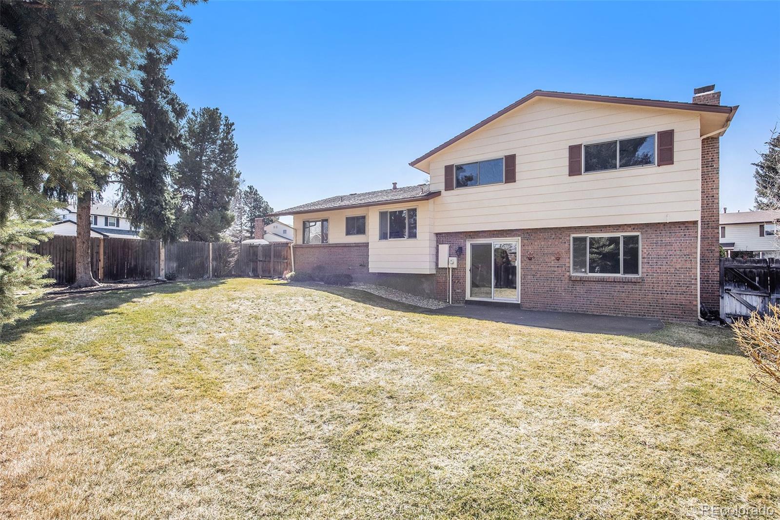 3792 South Fenton Way Denver, CO 80235 - Photo 7 of 19 a front view of a house with a yard