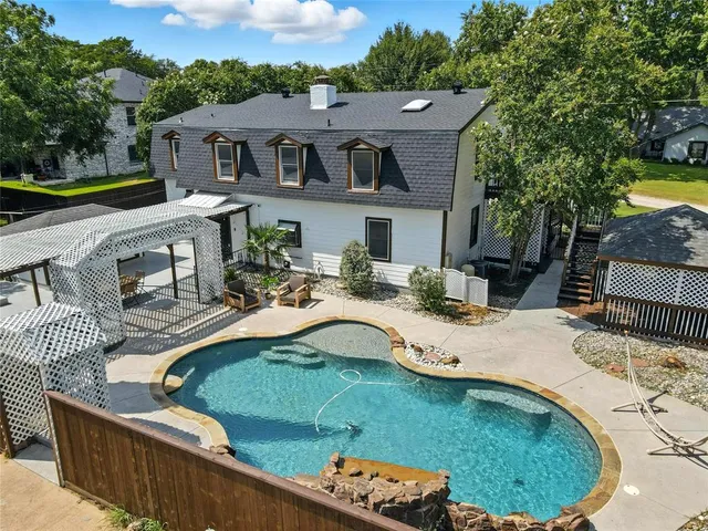 a living room with furniture a fireplace and a large window