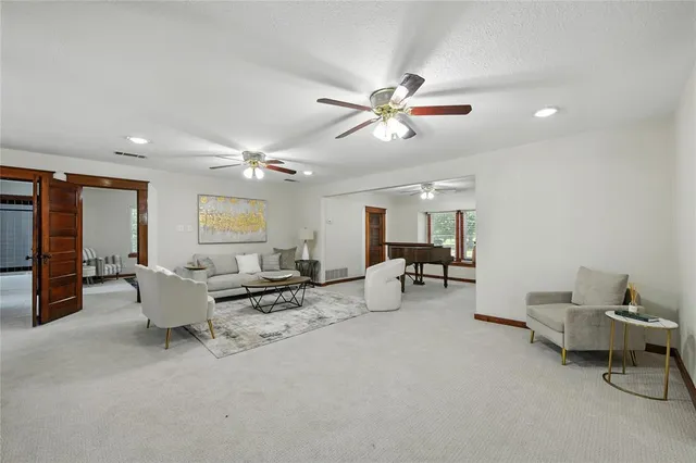 a living room with furniture and a chandelier
