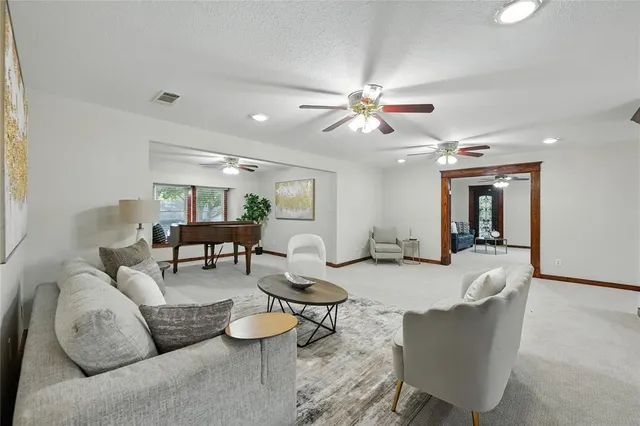 a spacious bathroom with a tub sink and mirror