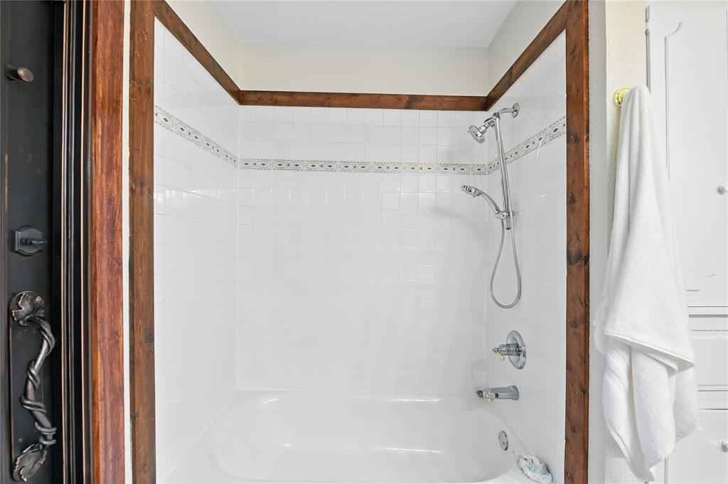 1323 Dublin Street Grapevine, TX 76051 - Photo 26 of 40 a bathroom with a shower and a glass door