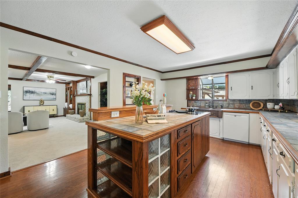 1323 Dublin Street Grapevine, TX 76051 - Photo 34 of 40 a kitchen with a stove a sink dishwasher and a refrigerator