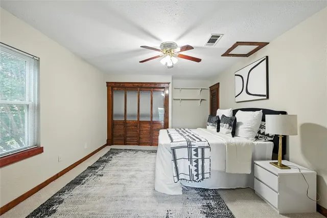 a bedroom with a bed and a window