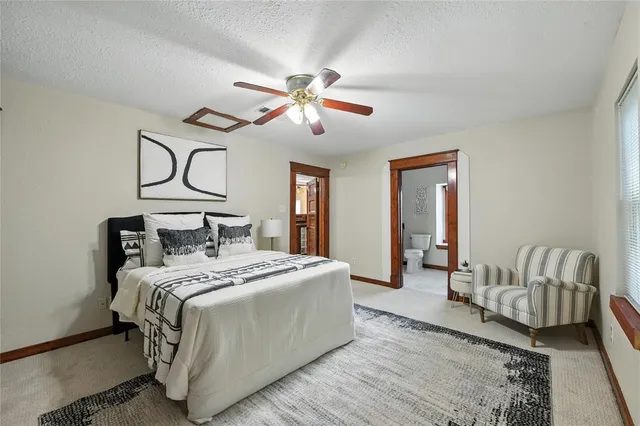 a bathroom with a granite countertop sink mirror vanity and toilet