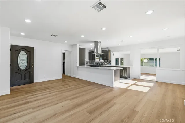 a large kitchen with kitchen island a sink stainless steel appliances and cabinets