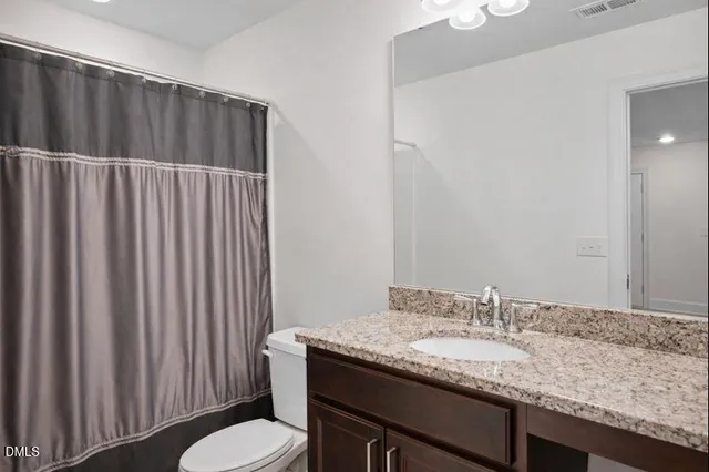 a bedroom with a bed couches and window