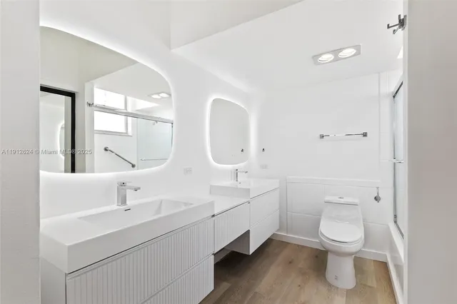 a bathroom with double vanity sinks and a mirror