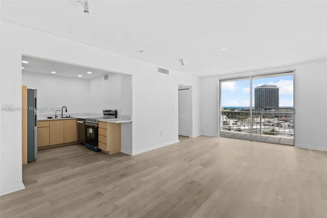 a view of a kitchen with a sink and a window