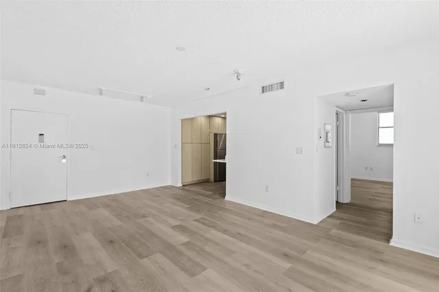 a kitchen with a sink and refrigerator