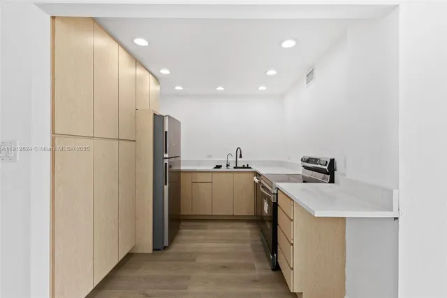 a close view of a sink a counter and appliances in a kitchen