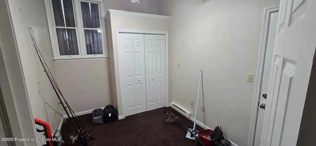 a hallway with a door and stairs