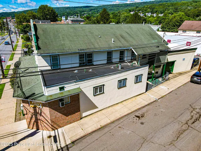 an aerial view of a house with a garden