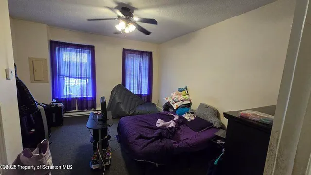 a view of walk in closet with clothes and washing machine