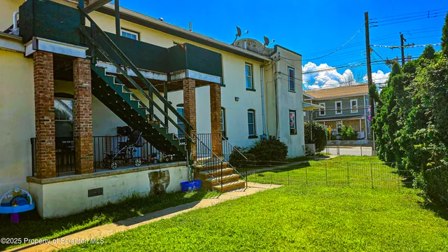 a picture of a wall with a clock and a potted plant