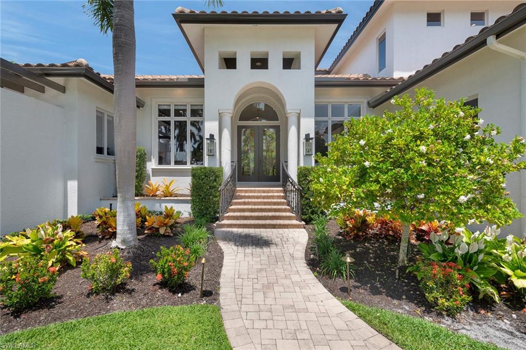 445 Putter Point Drive Naples, FL 34103 - Photo 3 of 34 a view of a pathway of a house with potted plants