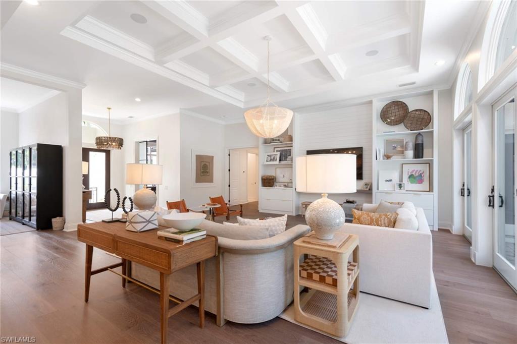 445 Putter Point Drive Naples, FL 34103 - Photo 9 of 34 a living room with furniture a large window and a table